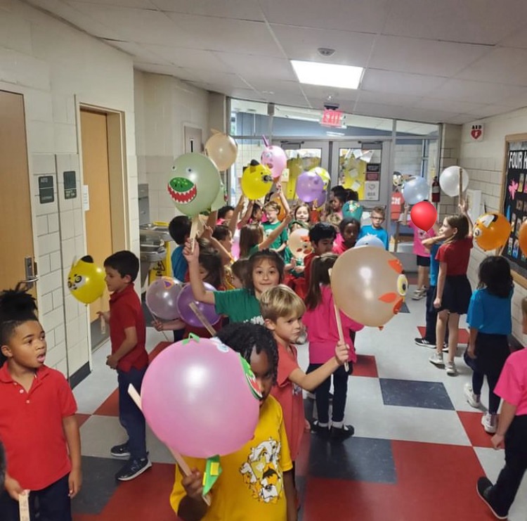 First grade students proudly waved their balloons in the parade.