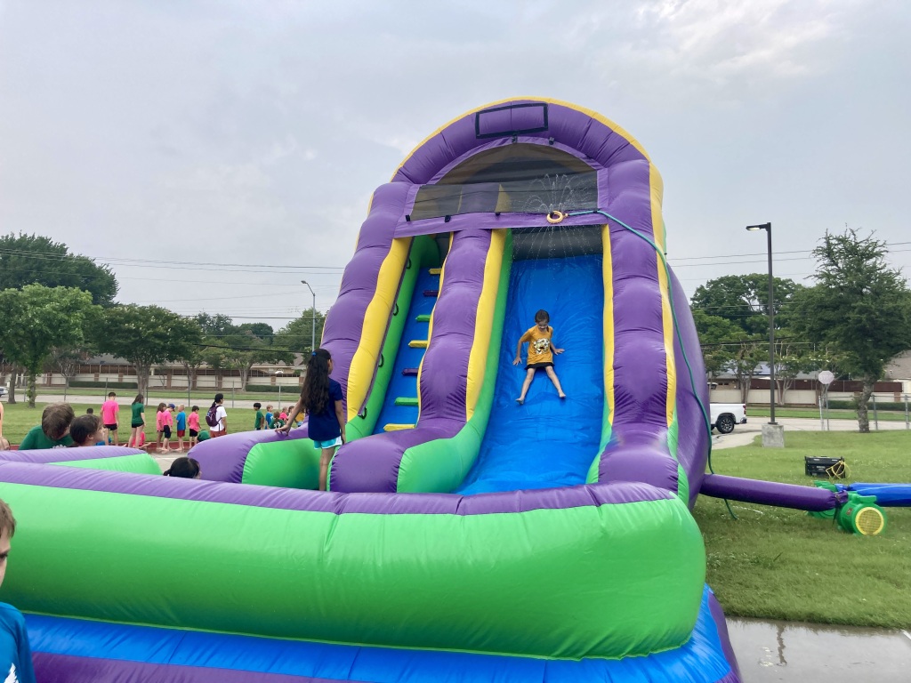 ACM students enjoy waterslides and games at Field Day.