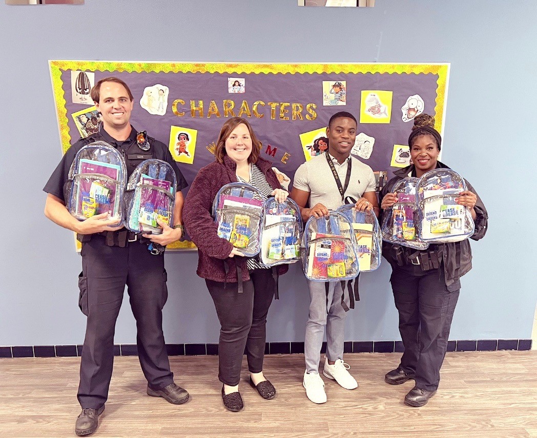 A picture of members of the Dallas police department, Ms. Shelton, and Mr. Goree with donated backpacks