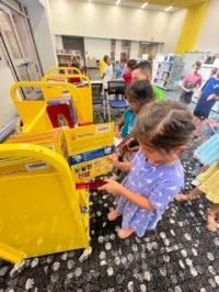 students looking at books on cart