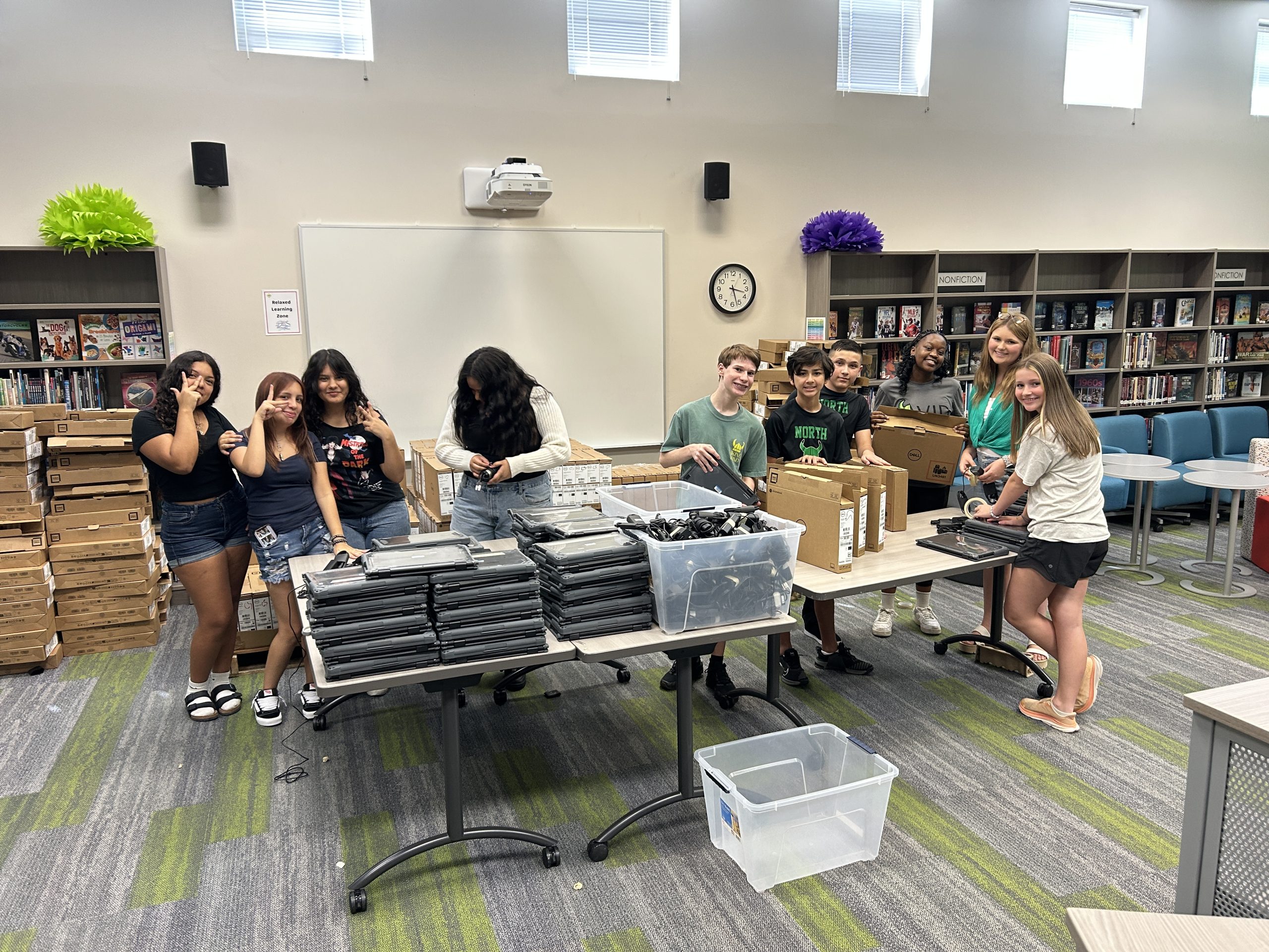 8th grade leaders helping prepare for Camp North Chromebook rollout.