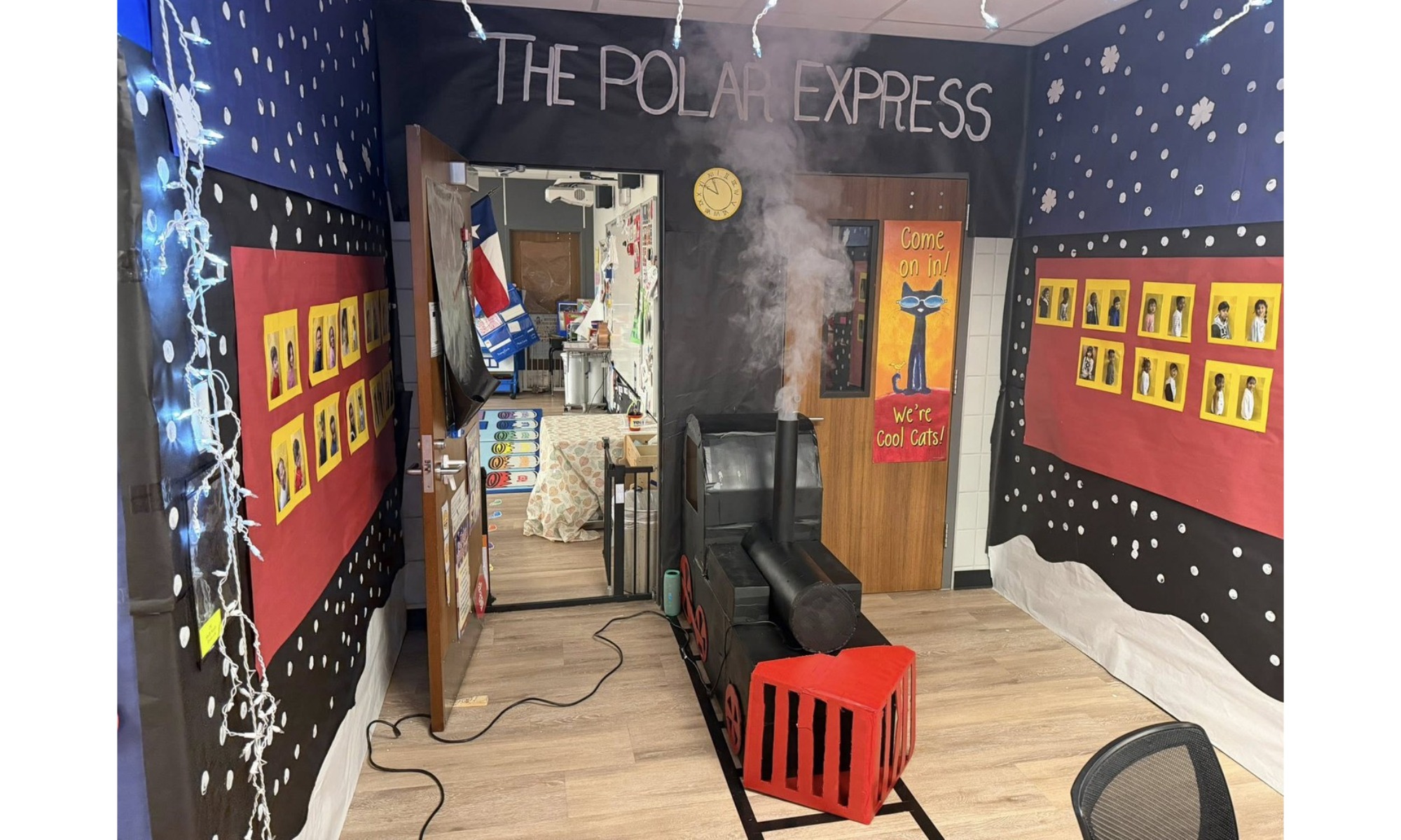 A classroom doorway decorated to look like the entrance to the Polar Express train with snowy decorations.