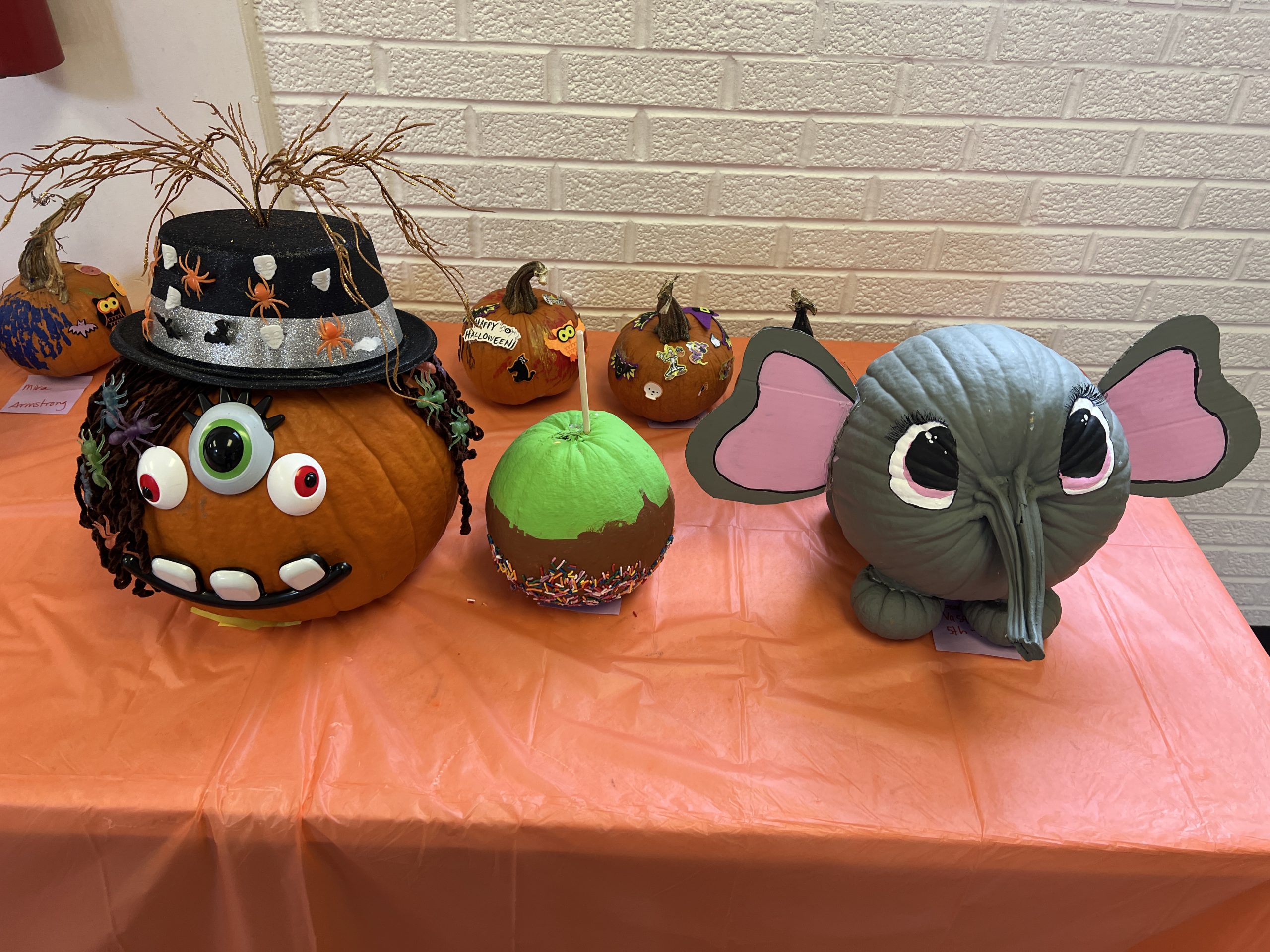 Students’ decorated pumpkins displayed on tables at Wallace Elementary’s annual pumpkin decorating contest, featuring creative and colorful designs.