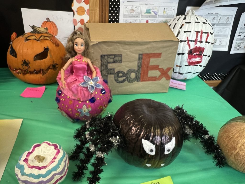 Students’ decorated pumpkins displayed on tables at Wallace Elementary’s annual pumpkin decorating contest, featuring creative and colorful designs.