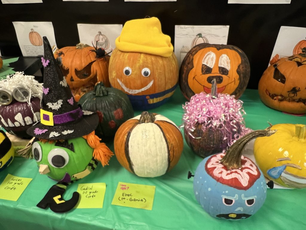 Students’ decorated pumpkins displayed on tables at Wallace Elementary’s annual pumpkin decorating contest, featuring creative and colorful designs.