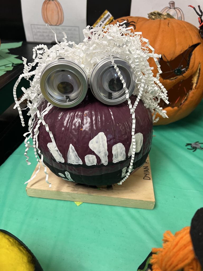Students’ decorated pumpkins displayed on tables at Wallace Elementary’s annual pumpkin decorating contest, featuring creative and colorful designs.