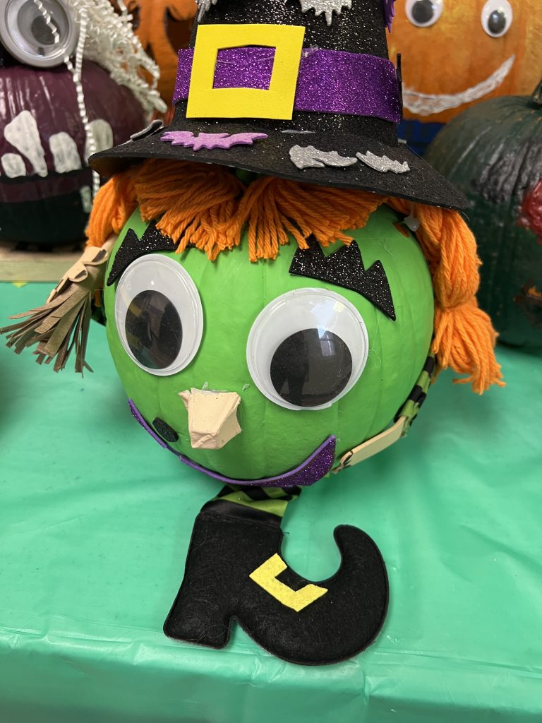 Students’ decorated pumpkins displayed on tables at Wallace Elementary’s annual pumpkin decorating contest, featuring creative and colorful designs.