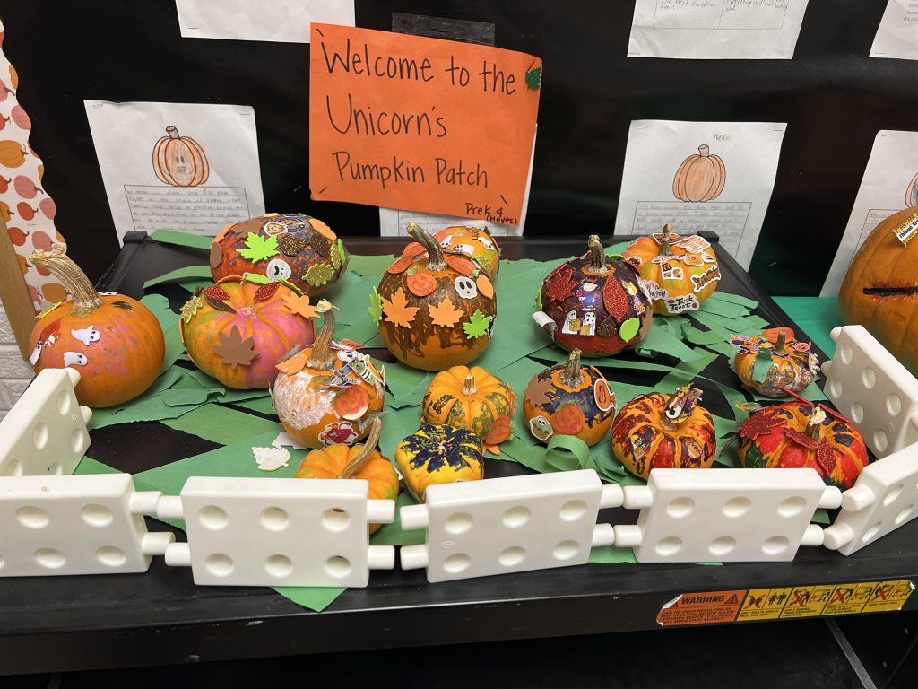 Students’ decorated pumpkins displayed on tables at Wallace Elementary’s annual pumpkin decorating contest, featuring creative and colorful designs.