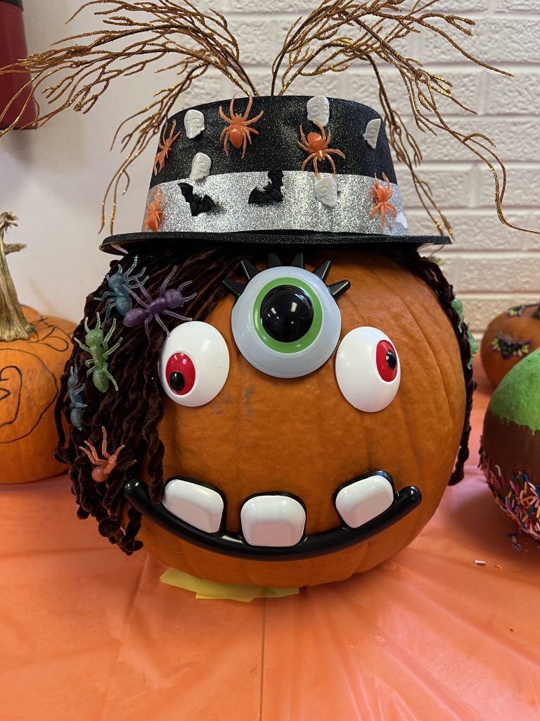 Students’ decorated pumpkins displayed on tables at Wallace Elementary’s annual pumpkin decorating contest, featuring creative and colorful designs.