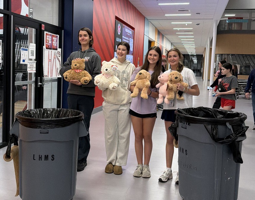 Students holding teady bears